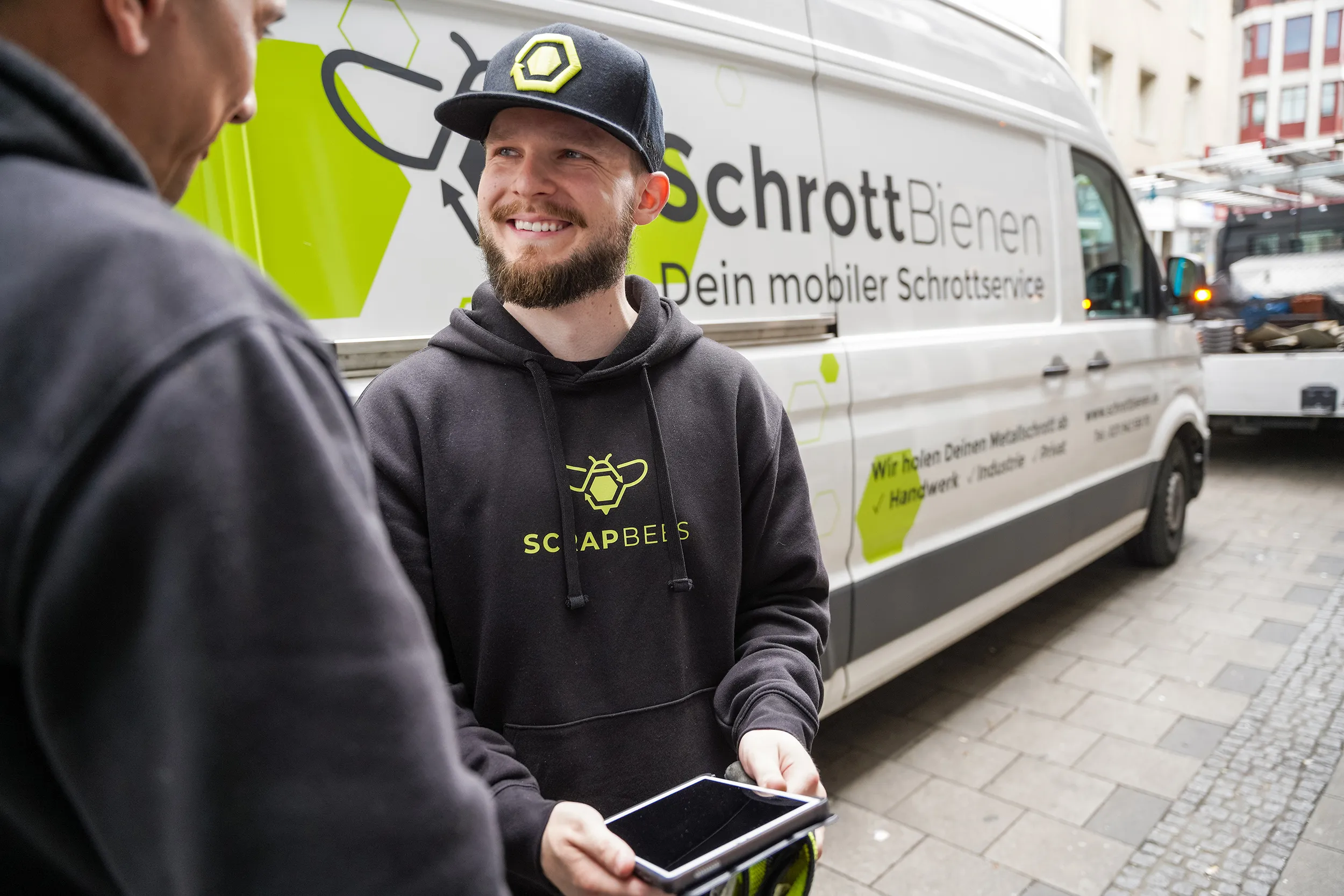 Driver with tablet in front of a transporter